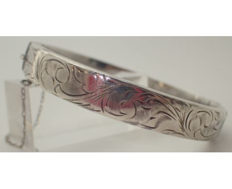 Hallmarked silver bangle with safety chain