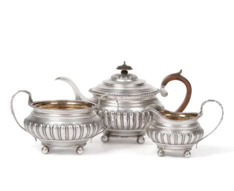 A George IV Silver Three Piece Tea Service, Charles Fox, London 1820, of squat circular form with gadroon border, fluted body