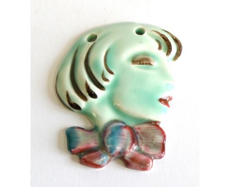 Clarice Cliff (British, 1899-1972): A Pendant Wall Mask, modelled as the profile of a young woman with short cropped hair and
