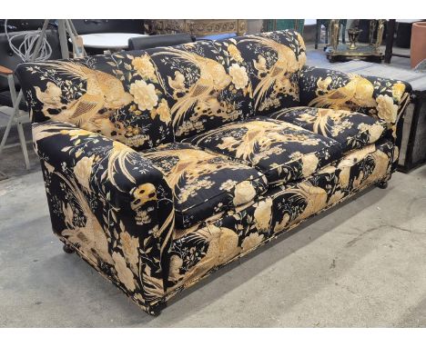 SOFA, in a black and gold bird fabric, approx 190cm W x 88cm H.