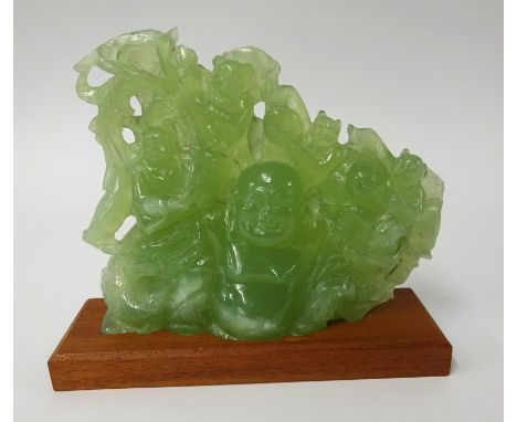 A carved 'jade' group depicting Buddha and laughing monkeys, height 18cm, width 22cm on later stand.