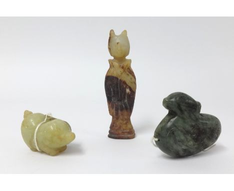 An oriental carved jade figure, a carved pig and dark green jade duck pendant, the tallest 7cm (3).