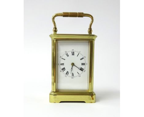 A French carriage clock the dial with roman numerals and outer ring of Arabic numerals, height 11cm, with travelling case.