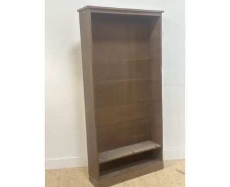 An oak framed upright open bookcase, with one shelf (h.207cm x l.100cm x w.27cm)