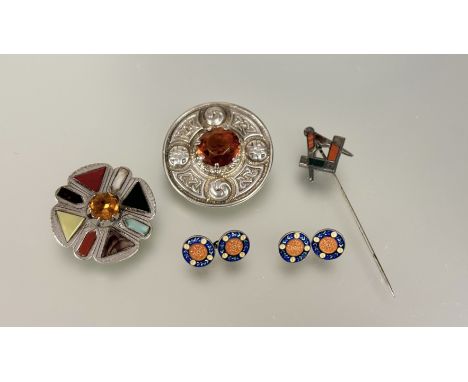 A Scottish silver cast Targe style brooch with amber glass central stone: d. x 5cm, a Glasgow silver brooch set polished hard