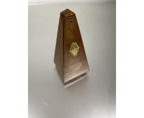 A Maelzel Paquet calssic walnut cased metronome of pyramid form three ball feet: h. x 23cm 