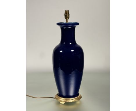 A lapus blue ceramic baluster shaped table lamp, raised on a gilt circular wooden base. (h-54cm)
