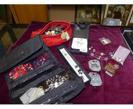 A quantity of costume jewellery including beaded necklaces, crucifix, clip on earrings, bangles, 925 silver cross and chain, 