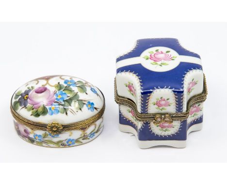 A Continental porcelain oval patch box and cover, painted with flowers and gilt lined scales, flower thumb piece, blue crosse
