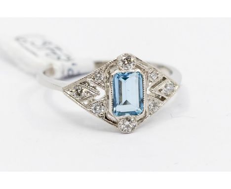 An aquamarine and diamond platinum ring, set to the centre with an emerald cut aquamarine, milled setting, stone weight appro