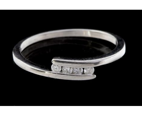 A diamond and platinum cross over ring, comprising four brilliant cut diamonds within a cross over band, total diamond weight