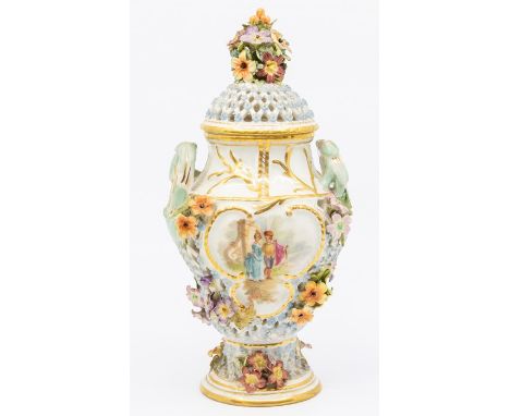 A German possibly Meissen two handled reticulated pot pourri and cover, the body painted with couple walking in landscape wit