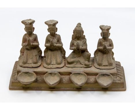 An Indian brass four burner oil lamp, decorated with deities, Length 18cm