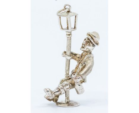 A novelty silver model of a man with lamp post, height approx 40mm, London 1975, marked FM, weight approx 0.39oztCondition re