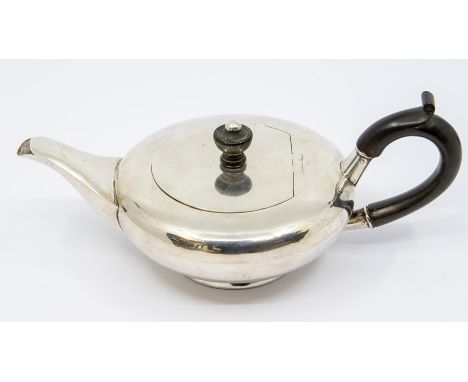An Edwardian plain silver squab teapot, ebony C-scroll handle and urn shaped finial, by William Neale, Birmingham ,1907, gros