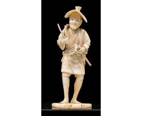 A Japanese Meiji period carved ivory Okimono of a Farmer, in hat with basket on back and fork in left handle, seal mark to ba