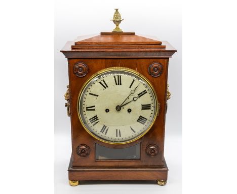 An early Victorian mahogany eight day bracket clock, the caddy top with a gilt metal acorn finial, the front with applied mou