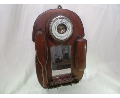 A hanging barometer and brush set.