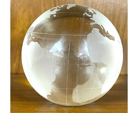 Hand etched glass paperweight globe features Earth's land features etched onto the crystal clear glass sphere,  in addition t