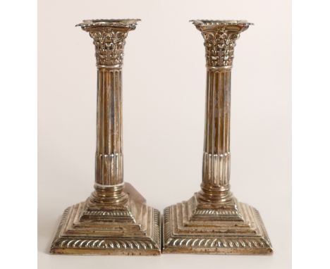 Pair of corinthian column hallmarked silver candlesticks, loaded.  Height 21cm, hallmarks for London 1905. Overall light dent