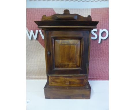 An Antique Smokers Cabinet, the cabinet has a single drawer beneath with the interior of the cupboard fitted with pipe hooks,