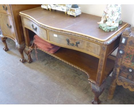 An Edwardian Bow Fronted Serving Buffet, having two drawers with shelf below, carved floral border and column supports, on ba