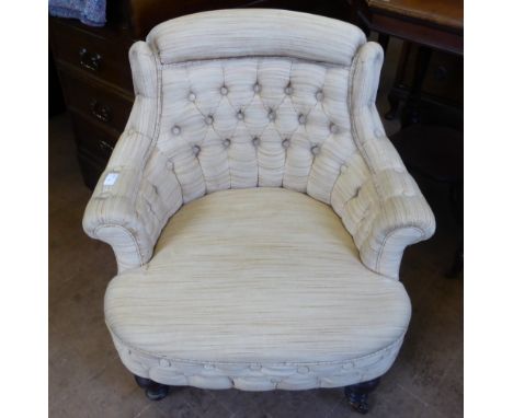 A Victorian Tub Chair, with button back upholstery, turned legs and casters.