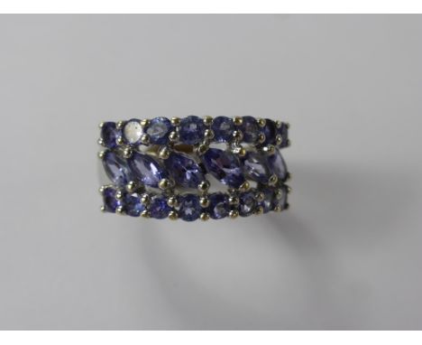 A Lady's 9 ct White Gold Tanzanite Ring, 16 x 2.6 mm and 6 x 4.6 x 2.6 mm tanz, size K, approx 3.4 gms.