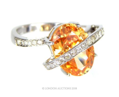 An 18 ct white gold, diamond and orange, faceted stone dress ring, Weight: 6.5 g, Ring size: O