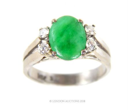 A 14 ct white gold, French, vintage, jade and diamond ring, central green jade cabochon flanked on each side by two brilliant