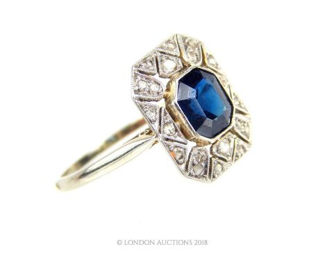 An 18 ct white gold and platinum, Art Deco, natural sapphire and diamond ring, the octagonal natural sapphire bezel set into 