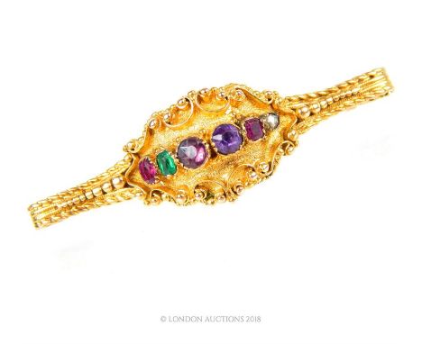 A mid 19th century, high carat yellow gold and gem studded brooch, the cast and granulated elongated panel frames a row of si