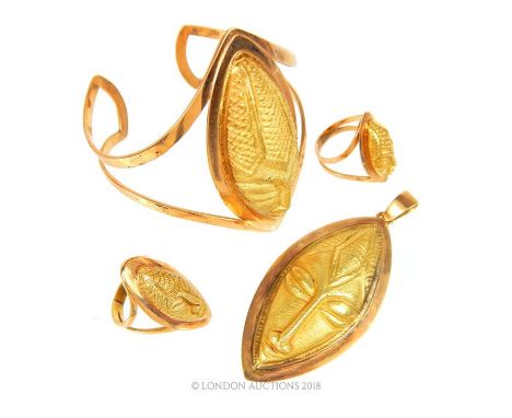 A unique, suite of tested 18 ct yellow gold, West African, vintage, elongated ladies face jewellery to include a large, cuff 
