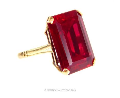 A 9 ct yellow gold, vintage, large, stepped cut, dark red stone, cocktail ring, Stone dimensions: 2 x 1.5 cm, size: O, Weight