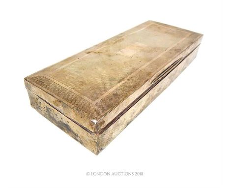 An Art Deco sterling silver cigarette box of elongated form, Harman Brothers, Birmingham 1936, with engine turned detail to t