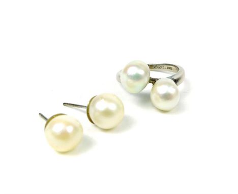 A solid 18 ct, white gold, vintage, ring composed of two large, Baroque pearls with matching stud earrings, the ring set cent