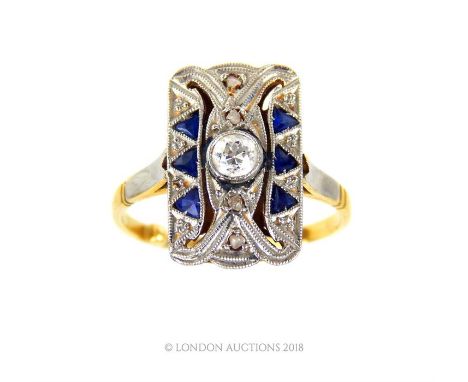 An 18 ct yellow gold and platinum, Art Deco, diamond and sapphire panel ring, the elongated panel centrally set with a round,