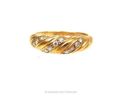 An antique, 9 ct yellow gold ribbed ring, inset with three curving bands of four brilliant-cut diamonds (twelve diamonds in t