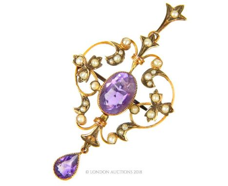 An Edwardian, 9 ct yellow gold, amethyst and seed pearl, drop pendant, featuring a fine, floral gold mount studded with seed 