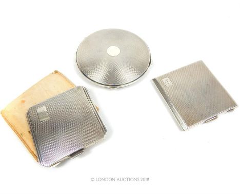 Three sterling silver compacts, including a circular example, David Sutton & Sons, London 1948, having engine turned decorati