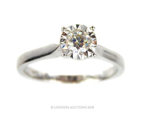 An 18 ct white gold, diamond solitaire ring, composed of a central, round, brilliant cut diamond in a four claw, illusion set