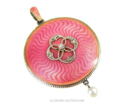 A late 19th century, silver gilt, pink guilloche enamel, circular locket/ pendant, the pink enamelled pendant loop to the cen