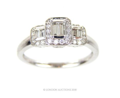 An exquisite, 18 ct white gold and 3 cluster diamond ring (0.60 carats), composed of three sections of stepped, graduated bag