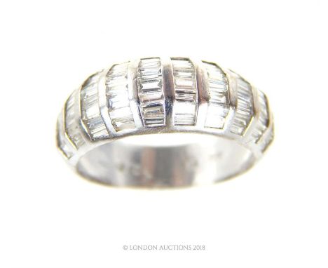 An 18 ct white gold, French, vintage, baguette diamond ring, composed of ten, curved, vertical rows of baguette-cut diamonds 