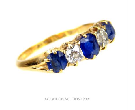 A spectacular, boxed, 18 ct yellow gold, diamond and sapphire, five stone ring, composed of two, cushion-shaped, brilliant-cu