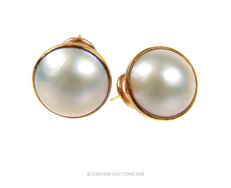 A pair of vintage, 9 ct yellow gold, large, circular-shaped pearl stud earrings, each earring composed of a central, gold-col