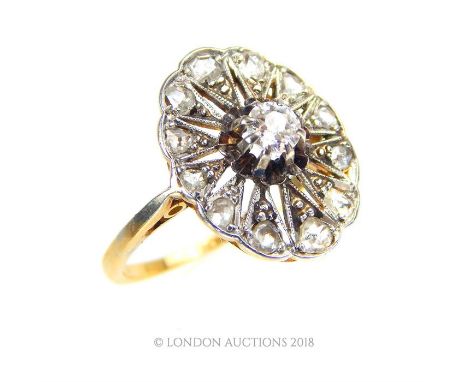 An 18 ct yellow gold and platinum, French, Belle Epoque, diamond ring, the central, oval-shaped delicately hand-pierced plaqu