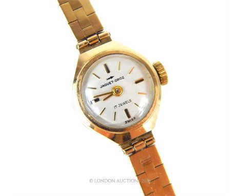 A 9 ct, vintage, ladies wristwatch and strap by Jaquet-Droz, the round, white enamelled dial set with gold elongated tab nume