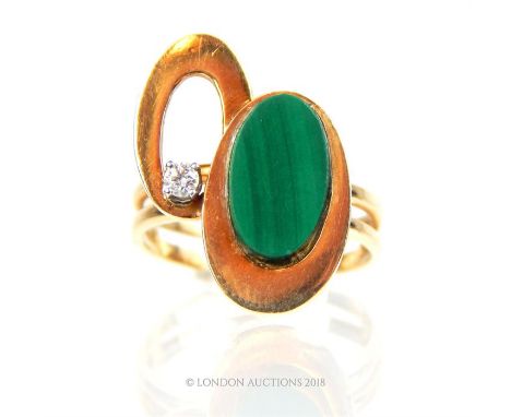 A 14 ct yellow gold, diamond and malachite, modernist ring, composed of two yellow gold discs, one set with a round, brillian