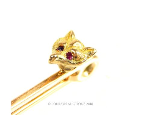 An 18 ct yellow gold, Victorian, pin brooch set at one end with a cast, yellow gold fox head with two ruby eyes on a solid, 1